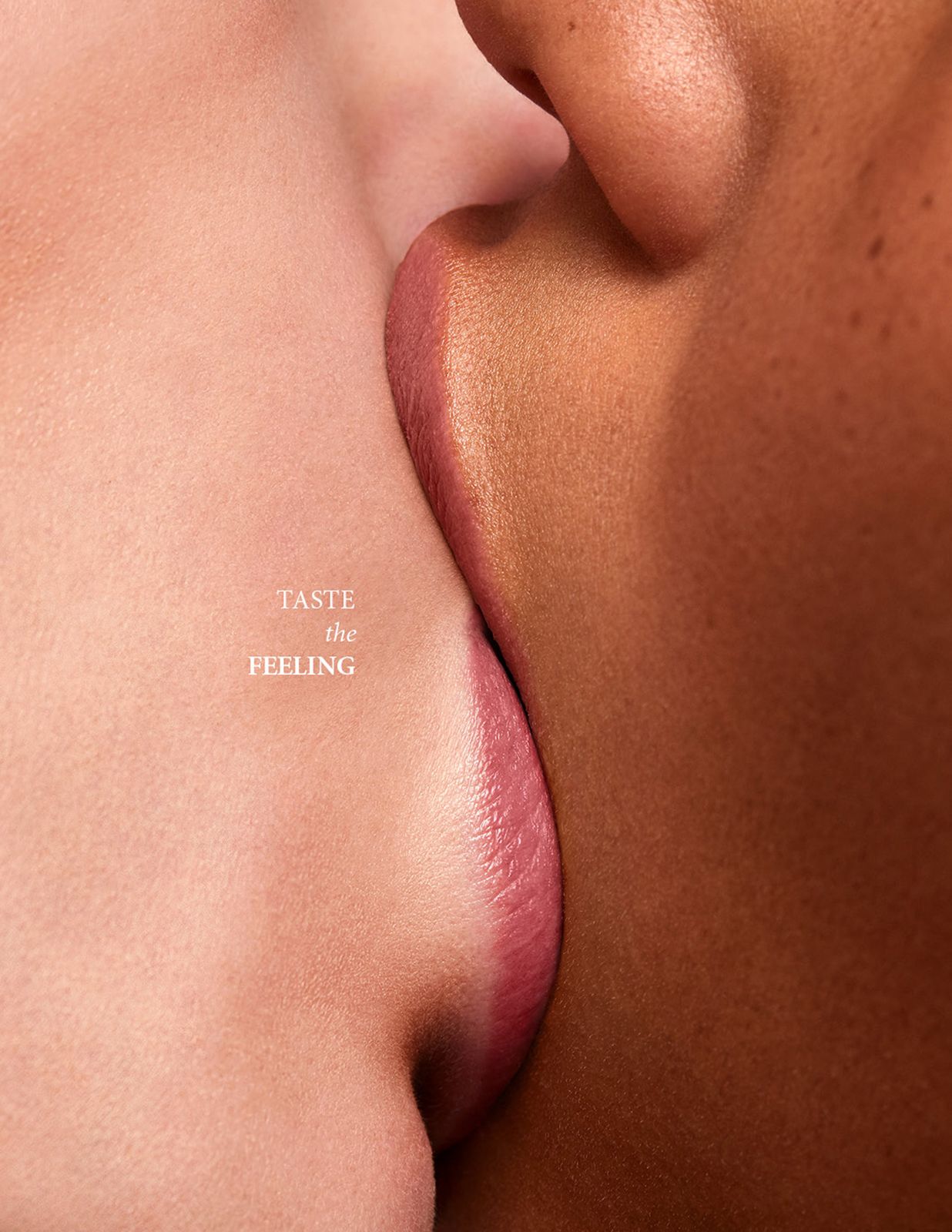 Warm brown skin and soft pale faces touching to form an iconic soda bottle shape