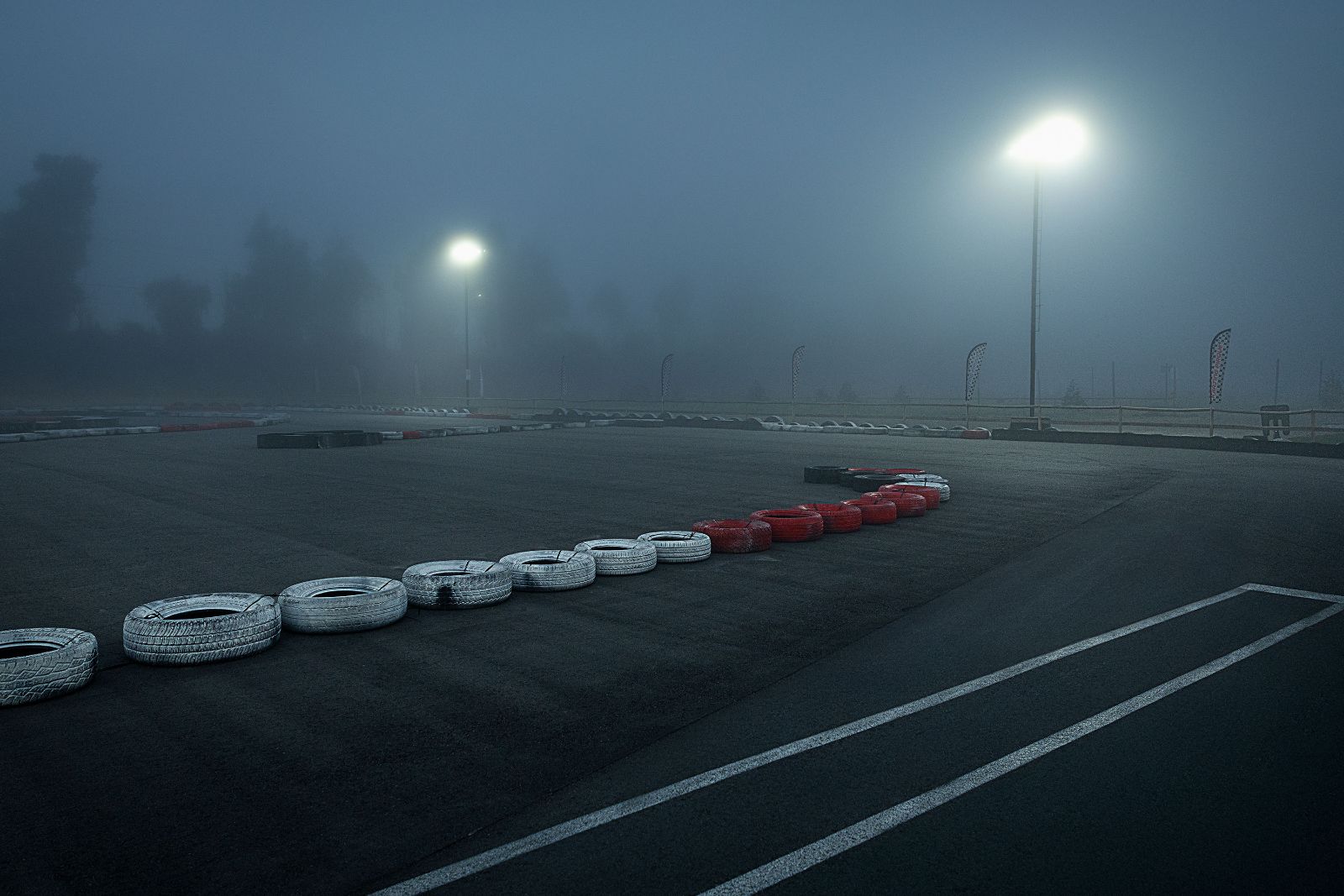 Empty kart track at dawn shrouded in heavy blue Chilean morning fog.