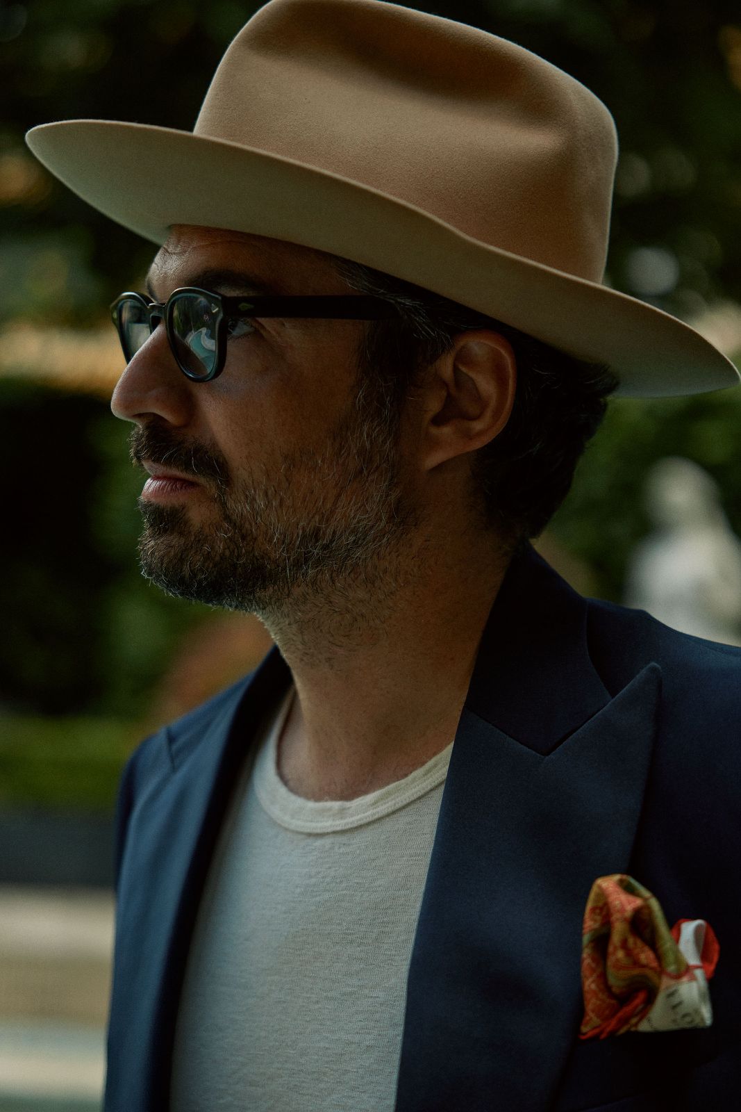 Side profile portrait of a man in a wide-brimmed hat in Florence.