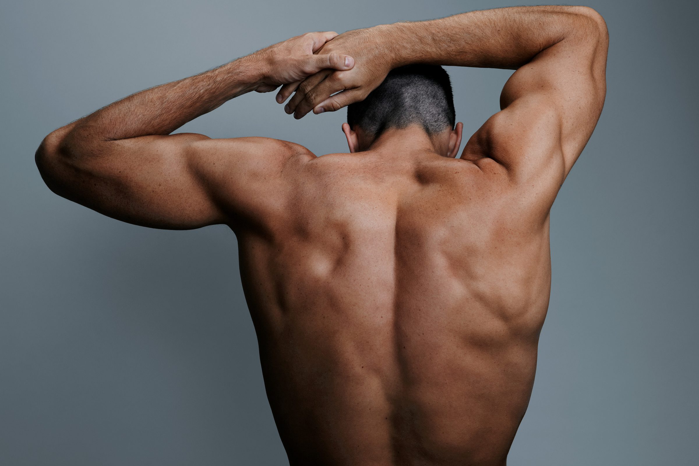 Michael's back opens like a range as he folds both arms behind his head.