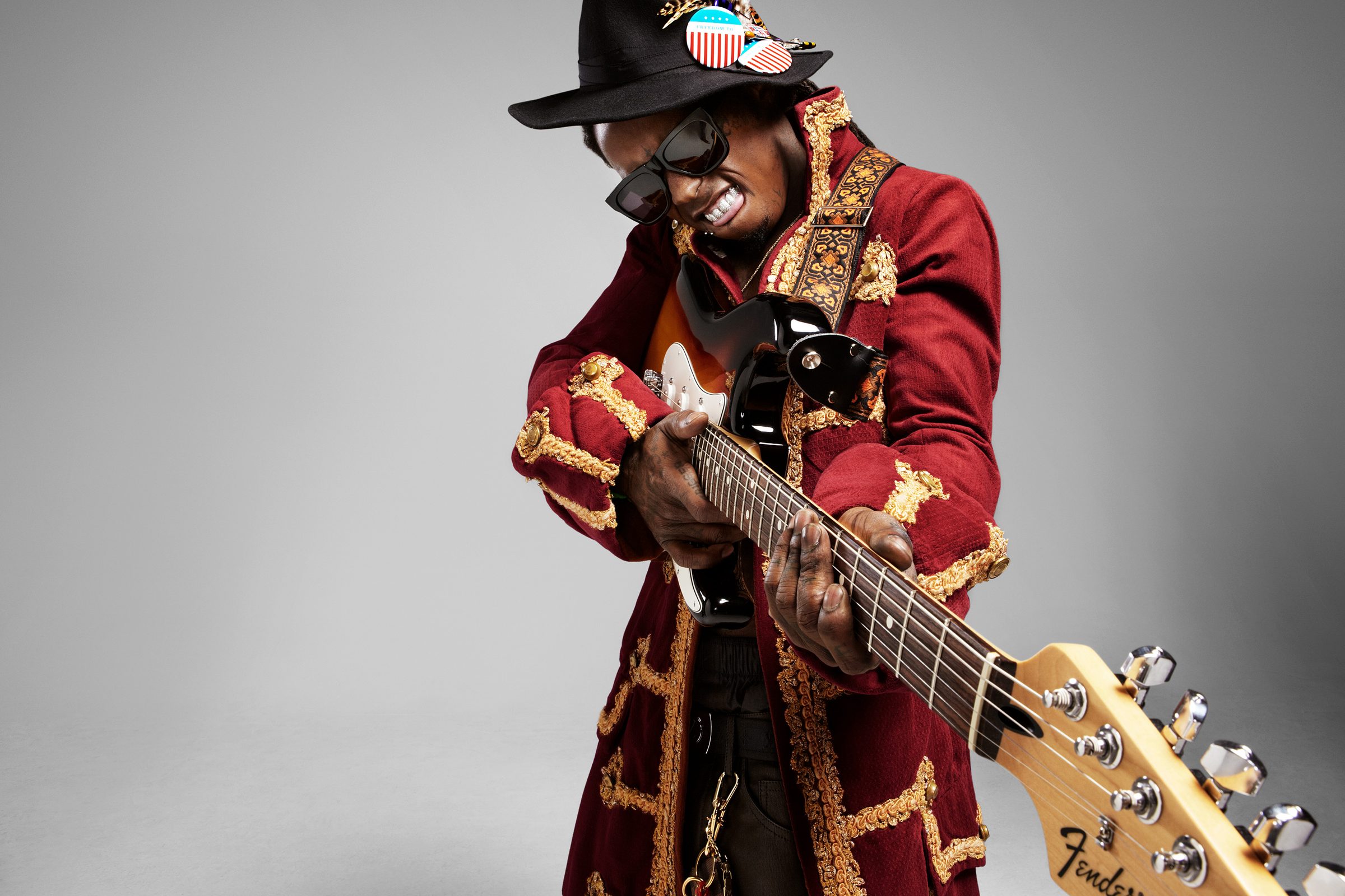 Teeth bared mid-riff, wringing the neck of the Fender like a note he refuses to let go.