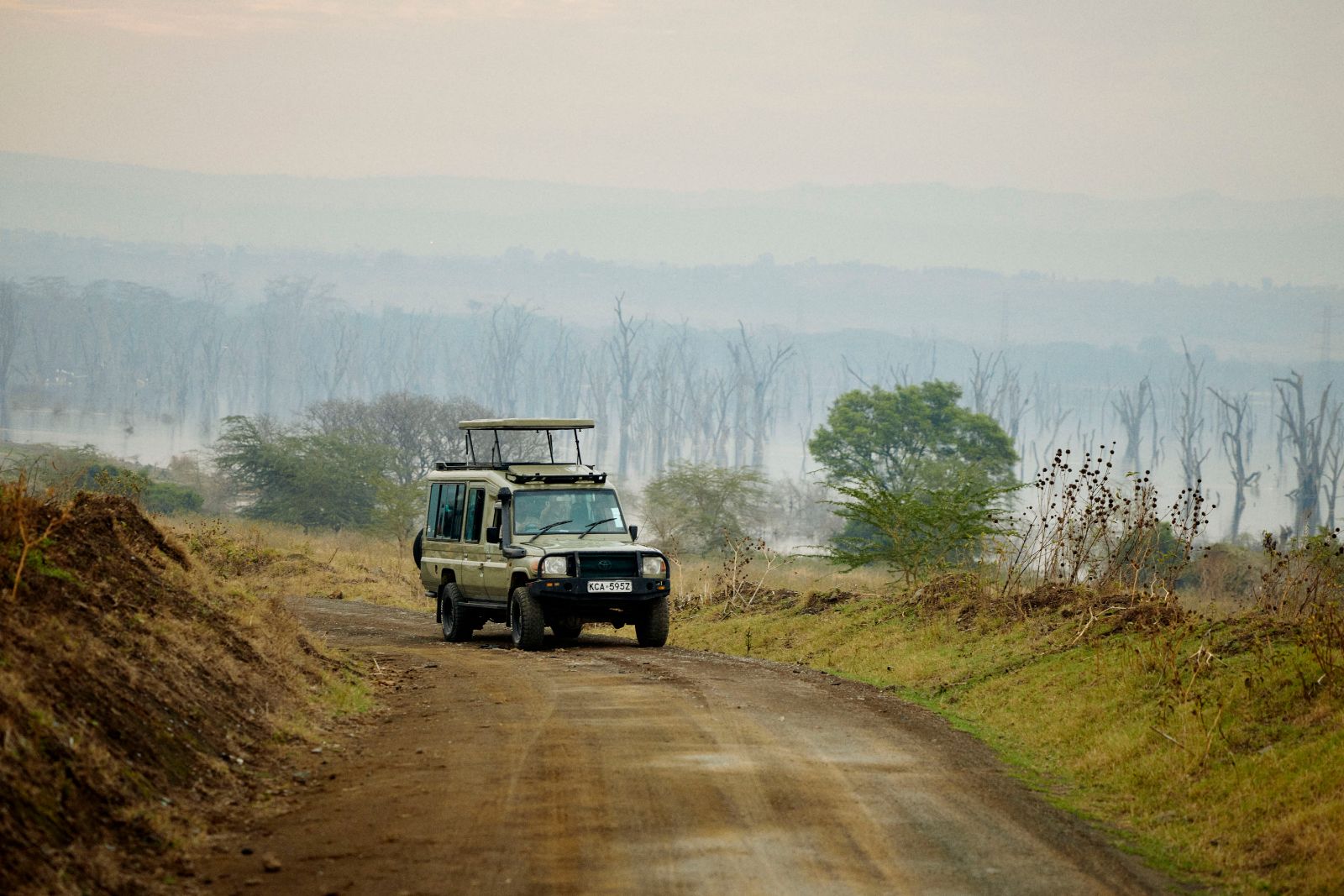 Our safari vehicle cutting through the morning mist.