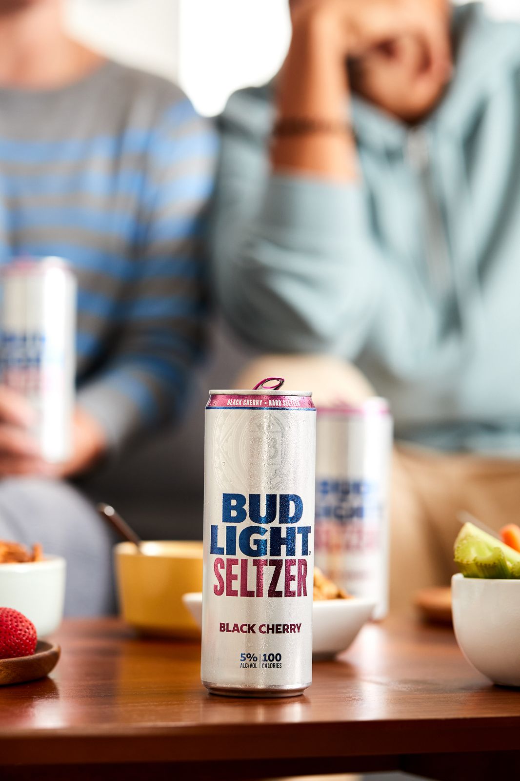 A sleek Black Cherry can positioned sharply against a softly blurred background.